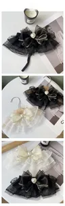 Close-up of mesh lace pet collar with heart pearl pendant and gold-edged bow detail