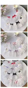 Detail view of lace pet collars with bowknots and heart pendants in four colors