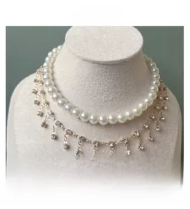 Close-up of double-layer pet necklace with white pearls and sparkling diamond tassels