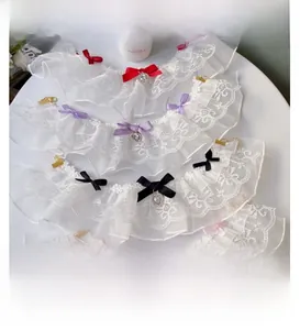Detail of double-layer lace pet collar with satin bow and heart crystal pendant