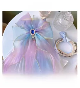 Detail of mermaid scale mesh pet harness with iridescent bow and sapphire gemstone decor