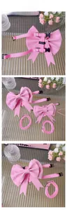 Detailed view of pink pet harness with large bow, adjustable nylon straps and metal D-ring