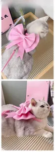 Detail of pink bow pet harness set showing soft faux leather texture and adjustable strap