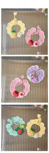 Detail display of handmade crochet pet collars featuring fruit and animal designs