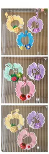 Detail showing various handmade crochet pet collars with fruit and animal motifs