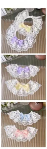 Detailed view of floral lace pet collars with ribbons and embroidery on glass surface