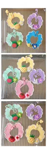 Detail showing various handmade crochet pet collars with fruit and animal patterns