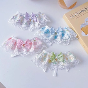 Detail of floral lace pet collars with satin bows and bells in four pastel colors