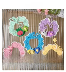 Detailed flat lay of handmade crochet pet collars with cute fruit and animal patterns