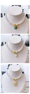 Detail of Chinese style pet pearl necklace with gold fortune beads and jade pendants