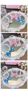 Close-up of pearl necklaces with sequined bows in pink, blue and rainbow colors