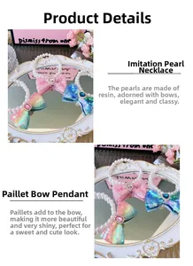 Close-up of pearl pet necklace with sequin bow and heart gemstone detail