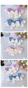 Detail of handmade knit pet collars with bows and pearls in purple, blue and pink