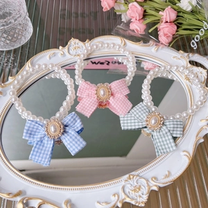 Sweet pearl pet necklace set with colorful plaid bows on a vintage white mirror tray