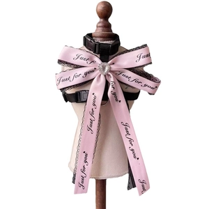 Pink satin bow pet harness with lace trim and rhinestone on a wooden display stand