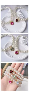Close-up of pearl pet necklace with heart-shaped crystal pendant in various colors