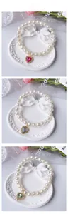 Detailed tile display of pearl pet necklaces with heart pendants in pink, green and opal