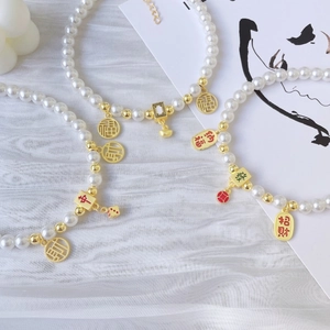 Elegant pet pearl necklace with gold Chinese fortune charms and mahjong tiles pendants