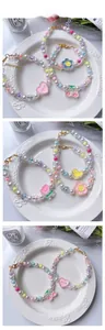 Macro view of adjustable beaded flower necklace with pastel charms and golden clasp