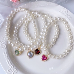 Elegant pearl cat collars with sparkling heart-shaped crystal pendants in four vibrant colors