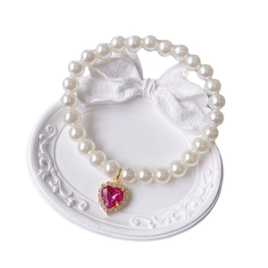 Elegant pearl pet necklace with a pink heart gemstone pendant and gold trim design