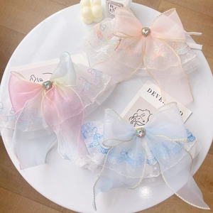 Close-up of lace embroidery pet hair clips with butterfly bows and heart crystals