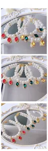 Detailed macro view of pearl pet necklaces with colorful gemstones and golden lobster clasps