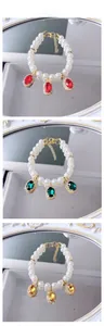 Detailed macro view of pet pearl necklaces with red green and amber gemstones
