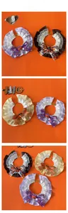 Detail of Halloween pet lace bibs with pumpkin charms and spooky pattern bows