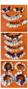 Detail of Halloween pet collars featuring pumpkin and ghost charms in four festive colors