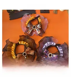 Detail of Halloween pet lace collars with pumpkin and ghost patterns and pearl bows