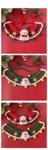 Detail of handmade crochet Christmas pet scarves with snowman and Santa Claus designs