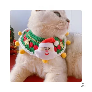 Detail of hand-knitted pet Christmas collar with Santa Claus 3D doll and gold stars