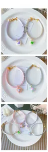 Detail of colorful heart pendants with silk luster cords in four different pastel shades