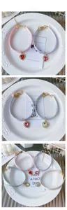 Close-up of four colorful heart crystal pendants on silk woven pet collar straps