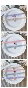 Detail of velvet pet collars with heart pendants in pastel colors and gold lobster clasps