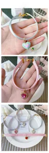 Detail of sweet heart pendant collars with glitter silk ribbons and gold chain