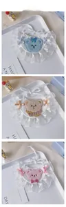 Detailed tile display of handmade knit pet bibs with lace trim and plush bear embroidery