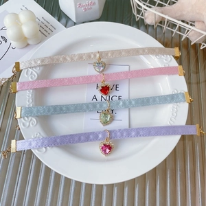Set of four velvet heart crystal collars in beige, pink, blue, and purple colors