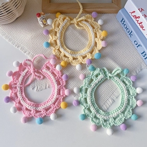 Handmade knitted pet collars with colorful pom-poms in pink, yellow and green