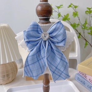 Light blue plaid pet collar with lace trim and heart crystal bow on a display stand