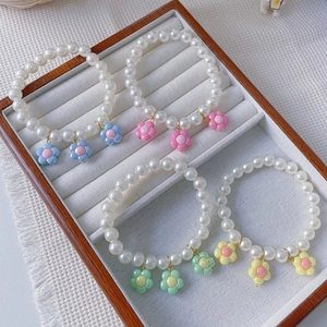 Handmade flower pearl necklaces for pets in blue, pink, green, and yellow floral designs