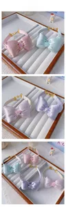 Detail of adjustable pet collars with satin bows and heart charms in four colors