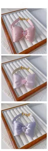 Detail view of adjustable pet bow tie collar with heart charm and satin texture