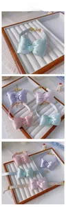 Detail of adjustable pet bow tie collars in pastel colors with heart crystal accents