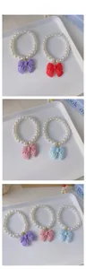 Detailed tile display of multi-color pearl necklaces with matte bows for small pets