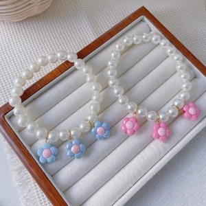Handmade flower pet pearl necklace with cute blue and pink floral pendants in a gift box