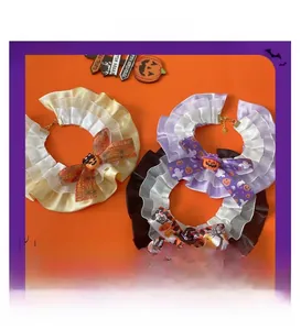 Detail of Halloween pet lace collars with pumpkin charms and spider web patterns