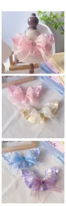 Close-up of pet lace collar with organza layers, large bow, and colorful heart gemstones