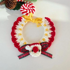 Detail of handmade crochet Christmas pet collar with reindeer and candy cane motifs